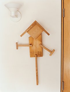 Raising the Barn - Photo 3 of 7 - In the bedroom, a "scarecrow" crafted by the Goodmans' grandson Eli hangs on the wall.