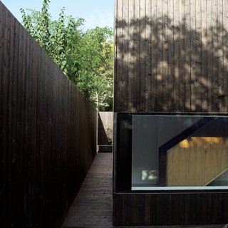 The outer walkway leads all the way around the structure, spilling into a small patio in back.