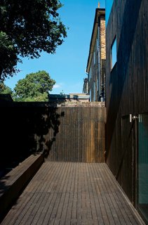 Even the rear facade is seamless—its door all but disappearing into the cedar cladding.