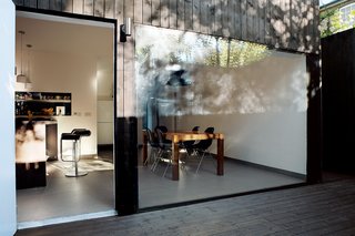 Windows range from the smallest of square portholes to wall-sized cinematic expanses of glass, as seen in the dining room.