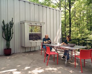 Compa and Cook relax on a patio at the western end of the house that overlooks a neighboring farm.