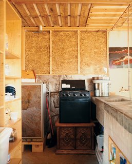 Kitchen and living room walls were constructed of clear and white acrylic panels stuffed with straw to allow for natural ventilation and light to filter softly into the house. The walls leaked after the first winter and the straw sank down in the frames. Students returned to the site, sealed and filled the walls with Styrofoam (leaving the straw-fill in the kitchen as is).