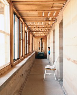 In wintertime, the rammed earth hallway wall serves as the central heating device, soaking up sunlight through south-facing windows and distributing warmth throughout the house. A wood-burning stove at the end of the front hallway provides additional heat for cold winter nights.