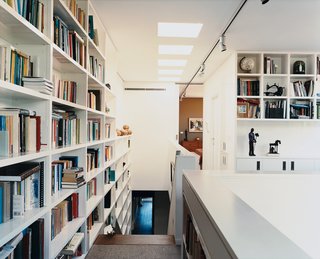 A wall of books travels the height of the stairs leading to Ann Wansbrough’s office, which rests comfortably on the top floor despite her limited mobility.