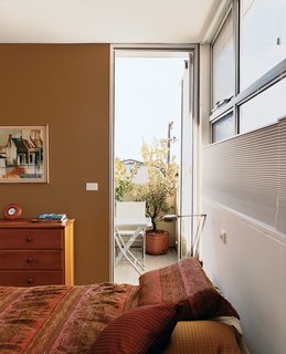 A small balcony off the master bedroom is both a sheltered area for reading and a crucial device for creating cross breezes.