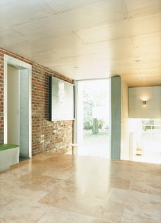 Home Schooled - Photo 6 of 9 - An area that once led from the original house to the garage is now enclosed and serves as a transitional space between the private and public areas of the house.