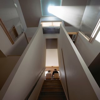 This House Tells the Time With an Oculus - Photo 4 of 6 - Architects Carrie and Kevin Burke designed their home to be a time-telling observatory. Sunlight is corseted through a 24-inch glass eye suspended just beneath a skylight, making the living room double as a sundial.