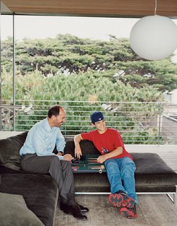 When not surfing, Lloyd-Butler and his son John repose in the new addition over a game of backgammon.