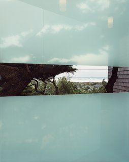 The frosted glass of the bridge offers a transparent stripe and a view of the ocean.