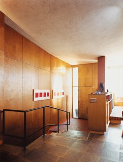The mahogany-paneled vestibule features gently angled stairs that rise to the living area, which boasts an impressive atrium.