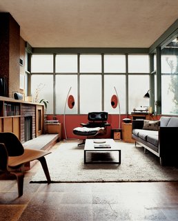 The bank of translucent glass windows diffuses light evenly in the living room and contributes to the sensation that you have left the world behind. Eames chairs for Herman Miller are accompanied by Italian manufacturer U-vola’s unique speakers from Elite Audio Systems.