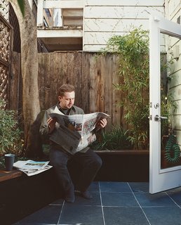 The miniature backyard was landscaped and now accommodates a Viking grill, a custom picnic table and benches by Ohio Design, and a nook which buttresses the small garden.