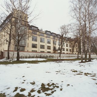 Palace Intrigue - Photo 1 of 13 - The renovated façade of Mikulionis’s flat, seen beyond thin snow and bare trees from the grounds of the monastery.