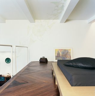 Palace Intrigue - Photo 9 of 13 - The platform bed was designed by the architect. The pattern on the ceiling was drawn by Rasa Baradinskiene, a local designer, in colored pencil over the off-white paint. Mikulionis and Marcinkeviciute don’t worry about slipping through the rails to the living room level below.