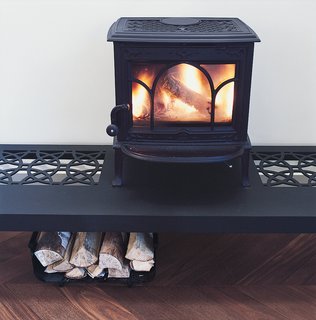 Palace Intrigue - Photo 11 of 13 - The wood stove roars atop a table designed by the architect.