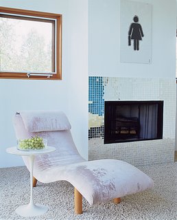 This chaise, found at a flea market and reupholstered in pink velvet adds texture to the decor.