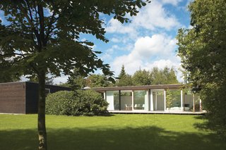 The main living space is constructed of immense I-profiles, allowing for a full wall of glass with four large sliding doors that open to the backyard.