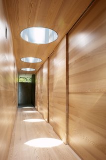 In the bedroom wing, sunlight shines down from the Plexiglass bubbles. Steel in the cutaways reflects the light.