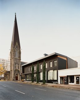 30 All-Black Exterior Modern Homes - Photo 26 of 30 - Referencing the First Presbyterian Church’s slate roof, 12 + Alder makes nice to its divine neighbor.