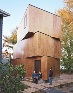 Four Houses and a Future - Photo 9 of 11 - Schenk, Kim, and Peeradorn Kaewlai (their friend and tenant) outside X-Small, the final piece of Schenk and Kim’s design puzzle, and hopefully their new home. Windows are strategically placed to maximize light and privacy.
