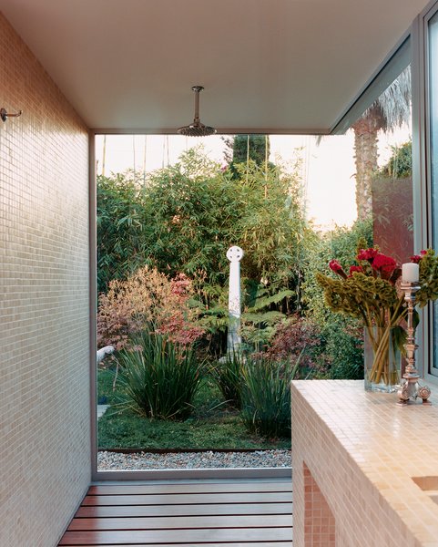 Venetian Vicissitude - Photo 6 of 9 - Only glass separates Farmer and Kozely from their backyard (and Celtic cross reproduction) when they shower. The shower floor is ipe wood; the walls are covered in one-inch-square travertine mosaics.