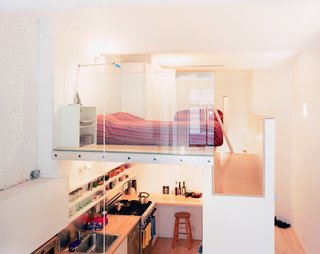 The volume that both incorporates the single closet (accessible from the hallway) and the refrigerator (which opens into the kitchen) and serves as the bedroom floor is, says Kyu Sung Woo, "where everything comes together."