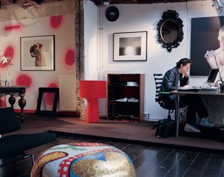 Wanders’s home is a combination of past (the pink wall design was painted for his daughter several years ago) and future (the ceiling and some walls were just removed to take the space into a new direction). The dog photo is by Boudewijn Smit; the black-and-white photo in the center is Sagami Bay by Hiroshi Sugimoto; and the print above the desk is by Ingrid Baars and Nanine Linning. The ornate mosaic coffee table Wanders designed for Bisazza is next to a minimalist sofa by Martin Visser. The red lamp is the smallest of Wanders’s Big Shadow series, designed in 1998 for Cappellini; above the desk is a lamp from Belgium’s Modular, and the office chair is from Vitra. The baroque mirror is a prototype of a design by Wanders.