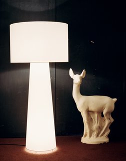 A luminous Big Shadow in white casts an ambient glow against a wall coated with blackboard paint and a chocolate brown carpet. The origin of the plaster deer figure has been forgotten. It was acquired as a possible inspiration source and has moved around the designer’s studio and home ever since.