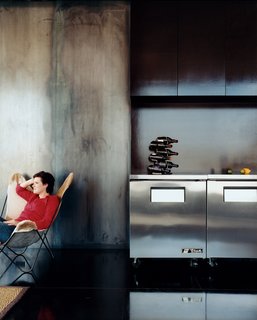 Xeros Effect - Photo 2 of 7 - Cold-rolled steel walls lend a bluish tint to the kitchen, which features cabinetry made of NAP, or North American plywood, which is a very dense plywood with a natural chocolate-colored finish.