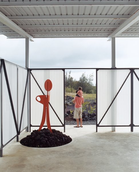 Go With the Flow - Photo 5 of 11 - The screen around the lanai is made from extrene, a material used by the military for radio towers. The welded-steel sculpture, set atop a pile of a’a rocks, was made by Craig.