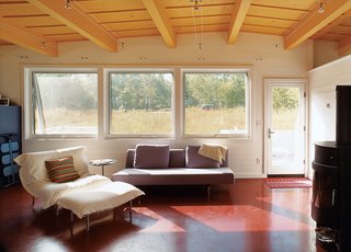 The living space gives first priority to comfort, and furniture pieces like the sofa bed by Niels Bendtsen deliver. The wood-burning stove by Rais is especially valued during wintertime visits.