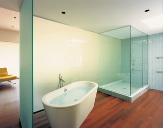 Seeing What Develops - Photo 1 of 5 - A translucent wall silhouettes a Duravit bathtub by Philippe Starck in the master bathroom.