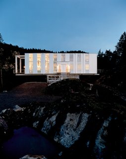 Looking like a jewel box at dusk, Scott Stafne’s Cantilever House rests easy in the middle of the Washington woods. With miles of hiking trails, lakes, and waterfalls to explore, Stafne’s property provides almost unlimited opportunity for outdoor adventures. The strong and sturdy house acts as a warm respite from the elements when the weather won’t cooperate, which is often—horizontal rain and whipping winds can be the norm.
