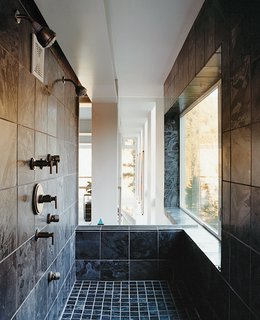 The master bath features a tiled shower—an optimal spot for viewing the intense weather.