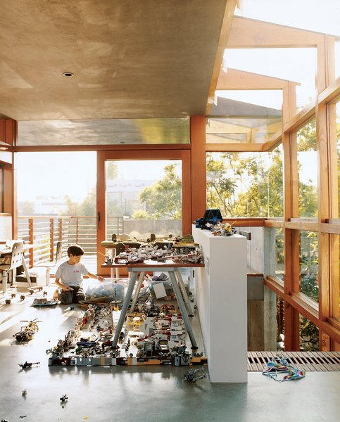 Sustainability in Stages - Photo 1 of 6 - In the new addition to the Hertz/Fong residence, the architect’s son Max tinkers with his extensive array of Legos and War Hammer miniatures in the upstairs office/playroom.
