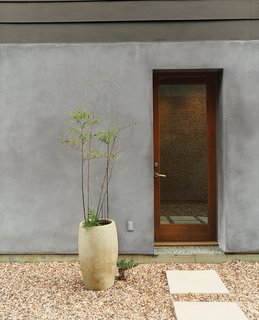 Designers Matt and Tina Ford created the concrete planters that dot the gravel courtyard. 