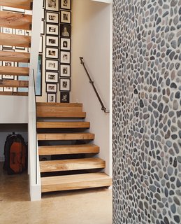 The metal used for the railing and wood for the stair treads in the hall were saved from destruction and reused. 