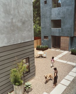 Unlike most Houston yards, there’s no grass to cut around these houses. Instead, the garden is gravel interspersed with low-maintenance plants like black bamboo, agave cacti, and foxtail ferns. Set inside concrete and steel planters that the Fords made themselves, the landscaping also hides protruding air conditioners. 