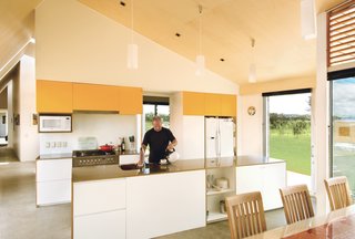 Long Division - Photo 3 of 5 - Ted Preston takes charge of hot beverages in the kitchen. The architects diligently avoided cold, hard minimalism with a honey-tinged Italian poplar ceiling.