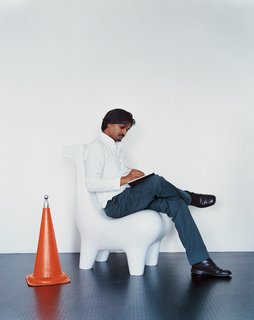 Pure and Symbol - Photo 1 of 10 - The designer is pictured here on a prototype of his Horse chair, a design that has become iconic for him. Eminently suited for a wide variety of settings, the seat has been executed in materials using bell metal and Corian.