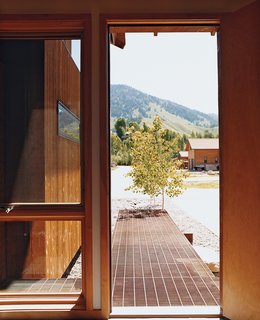 A raised oxidized-steel-grate walkway provides a low-impact, richly textured alternative to the traditional stone walkway.