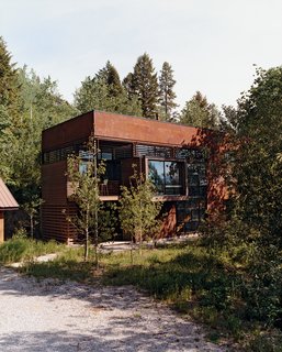 The simple frame of the Stanwood residence is clad with oxidized steel finished with linseed oil and outfitted with Sierra Pacific windows and doors.