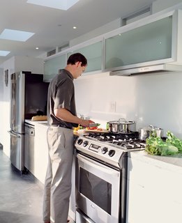 Reitz in the kitchen, which is outfitted with efficient fluorescent lighting and Energy Star appliances.
