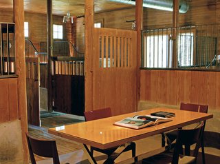 The largest stall (below), formerly used for washing thousand-pound animals, was the perfect size for a meeting room.