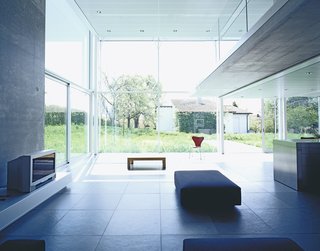 A Tale of Two Houses - Photo 1 of 6 - A view toward the garden from the living room (right) gives perspective to the double-height space.