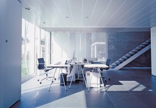 A Tale of Two Houses - Photo 3 of 6 - The office area, complete with Eames aluminum management chairs and desks from Atelier Alinea, can be completely sealed off from the rest of the house.