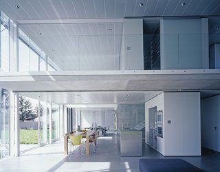 A Tale of Two Houses - Photo 4 of 6 - An electronically controlled louver shading system protects the glass façade of the kitchen, office, and upstairs open-plan bedroom from the sun.