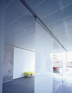A Tale of Two Houses - Photo 5 of 6 - The movable glass partitions in the second floor of the office space provide privacy and translucent natural light (the space also serves as a guest room).