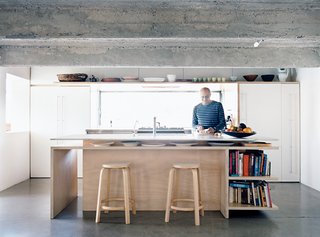 The kitchen includes ceiling lights whose fittings are recessed and offset; their glow is both diffuse and elusive.