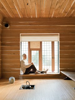 The Tanpopo House's family tearoom is an updated take on Japan’s traditional flexible, open-plan tatami-mat room. Here, the charcoal fire pit for the teapot is an electric coil embedded in the floor, and the flooring is a durable rattan from Indonesia. Plaster oozing in between oak planks gives the room a warm, rough-hewn feel—a Fujimori signature.
